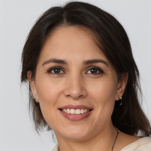 Joyful white young-adult female with medium  brown hair and brown eyes