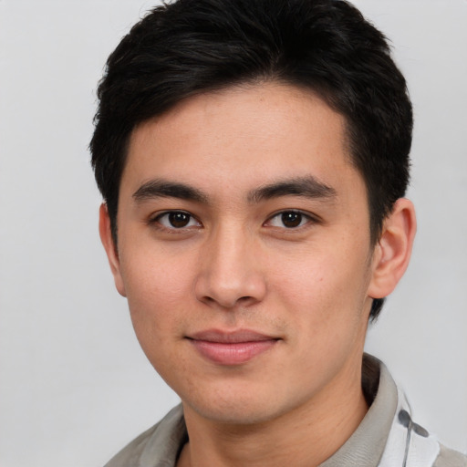 Joyful asian young-adult male with short  black hair and brown eyes