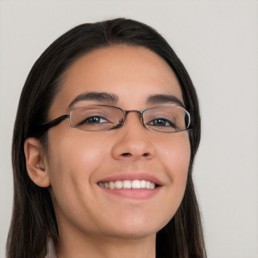 Joyful white young-adult female with long  black hair and brown eyes