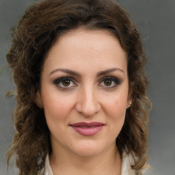 Joyful white young-adult female with medium  brown hair and green eyes