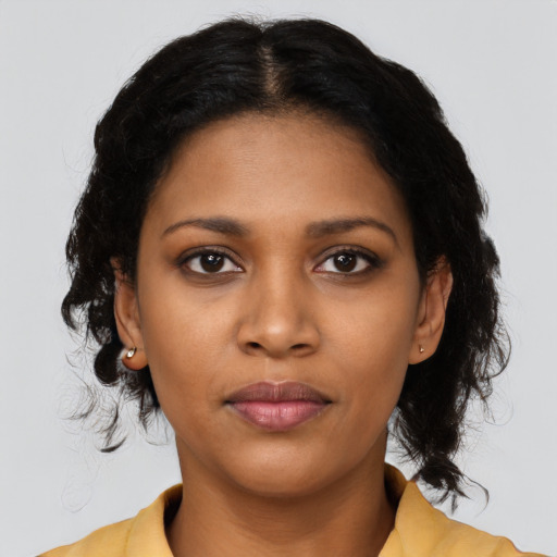 Joyful black young-adult female with medium  black hair and brown eyes