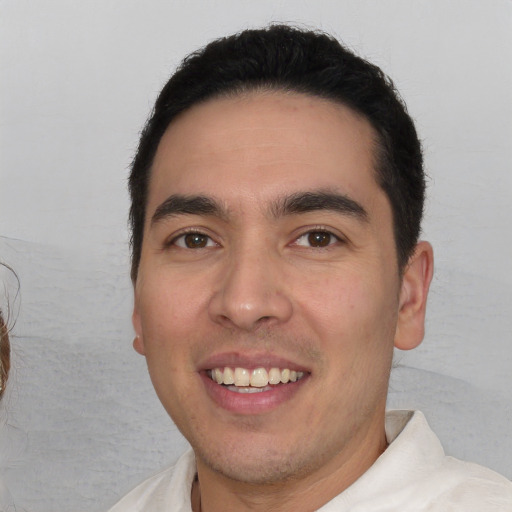 Joyful white young-adult male with short  black hair and brown eyes