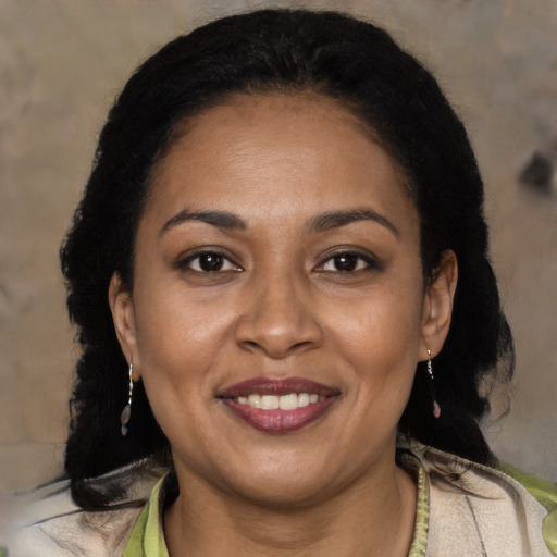 Joyful latino adult female with medium  brown hair and brown eyes
