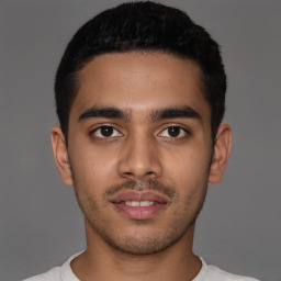 Joyful latino young-adult male with short  brown hair and brown eyes