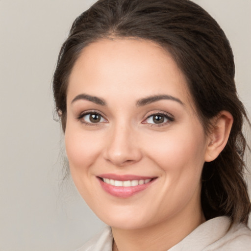 Joyful white young-adult female with medium  brown hair and brown eyes