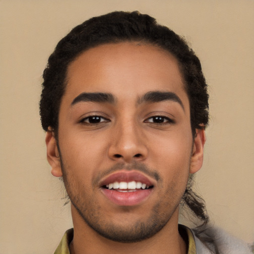 Joyful latino young-adult male with short  black hair and brown eyes