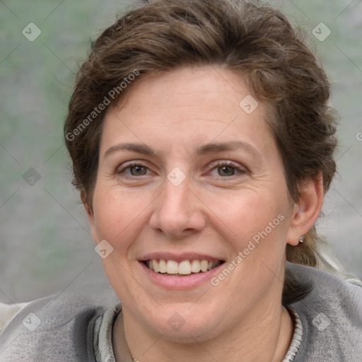 Joyful white adult female with short  brown hair and grey eyes