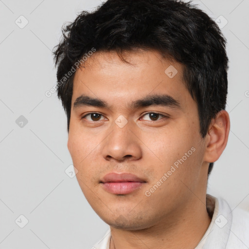 Joyful asian young-adult male with short  black hair and brown eyes