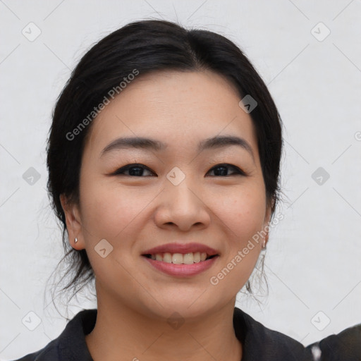 Joyful asian young-adult female with medium  black hair and brown eyes