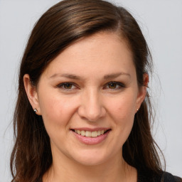 Joyful white young-adult female with long  brown hair and grey eyes