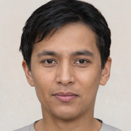 Joyful asian young-adult male with short  black hair and brown eyes