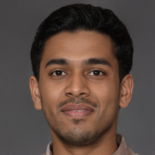 Joyful latino young-adult male with short  black hair and brown eyes
