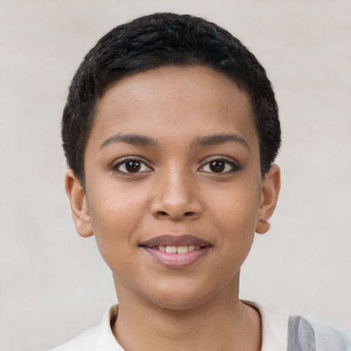 Joyful latino child female with short  black hair and brown eyes
