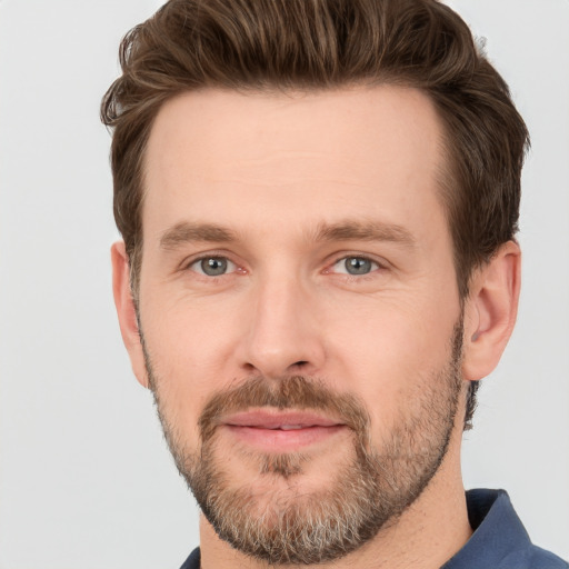 Joyful white adult male with short  brown hair and grey eyes