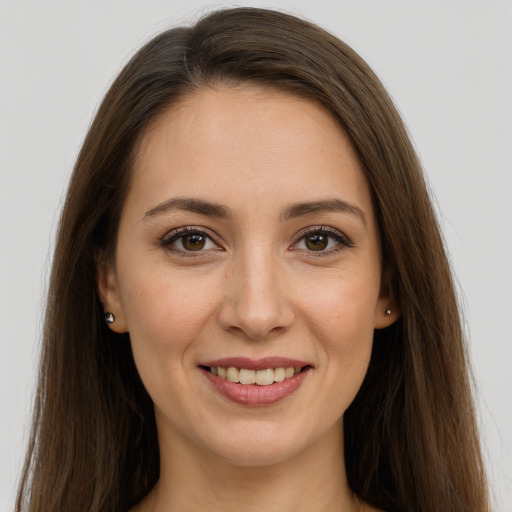 Joyful white young-adult female with long  brown hair and brown eyes