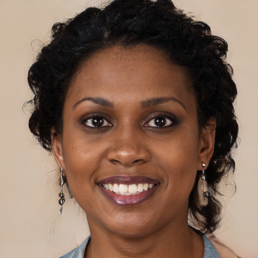 Joyful black young-adult female with medium  brown hair and brown eyes