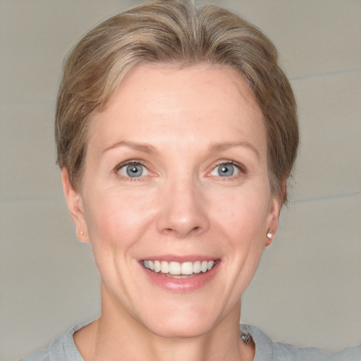 Joyful white adult female with short  brown hair and grey eyes