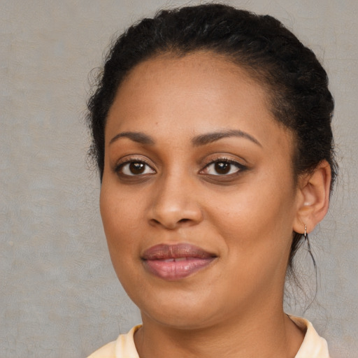 Joyful black young-adult female with short  brown hair and brown eyes