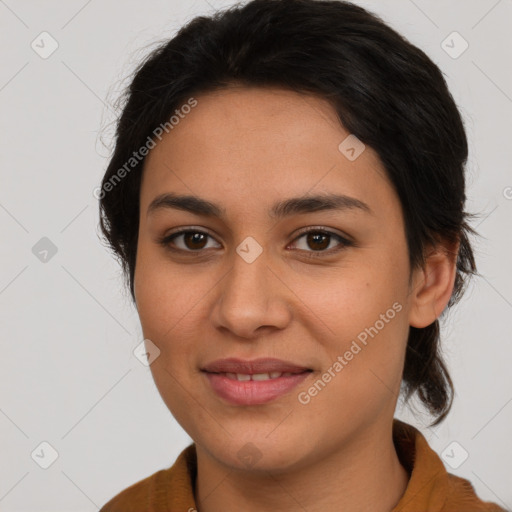 Joyful latino young-adult female with medium  brown hair and brown eyes