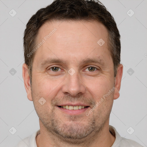 Joyful white adult male with short  brown hair and brown eyes