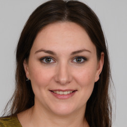 Joyful white young-adult female with medium  brown hair and brown eyes