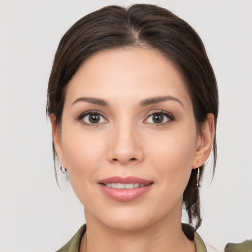 Joyful white young-adult female with medium  brown hair and brown eyes