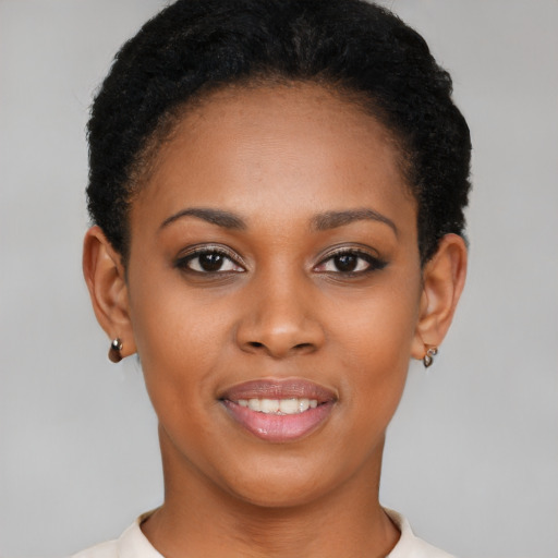 Joyful black young-adult female with short  black hair and brown eyes