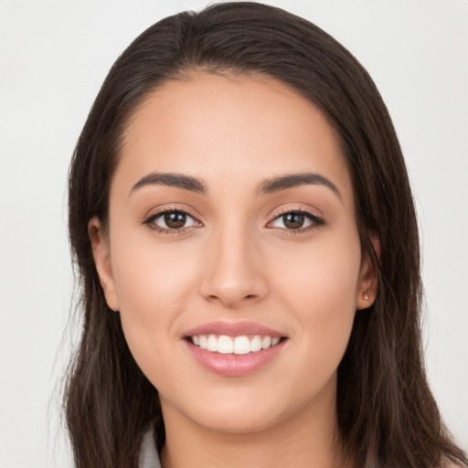 Joyful white young-adult female with long  brown hair and brown eyes