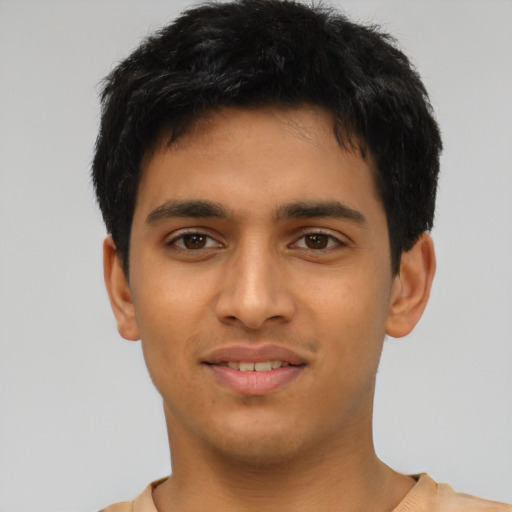 Joyful latino young-adult male with short  brown hair and brown eyes