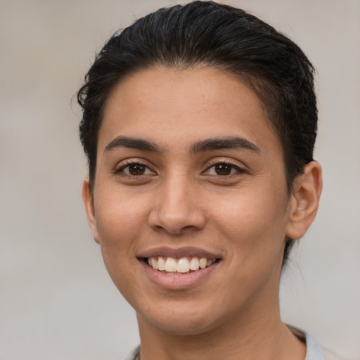 Joyful latino young-adult female with short  brown hair and brown eyes