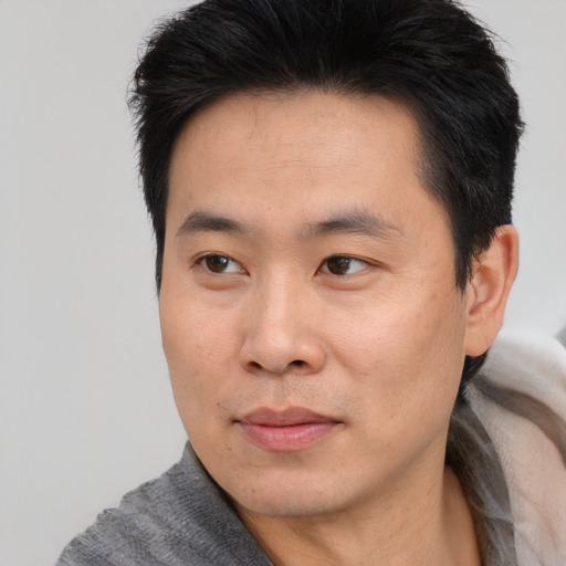Neutral asian young-adult male with short  black hair and brown eyes
