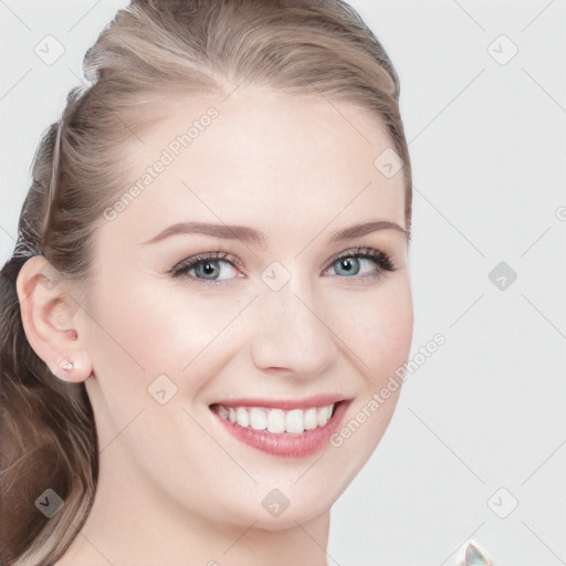 Joyful white young-adult female with long  brown hair and blue eyes