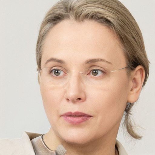 Joyful white adult female with medium  brown hair and grey eyes