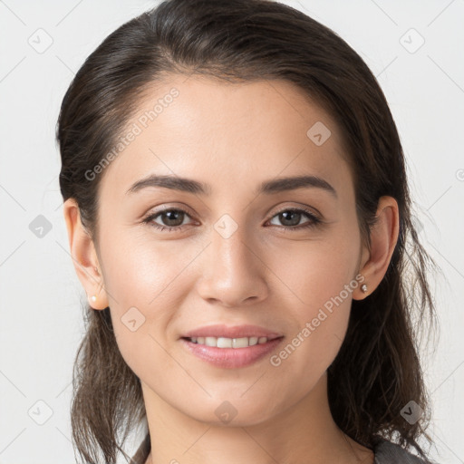 Joyful white young-adult female with long  brown hair and brown eyes