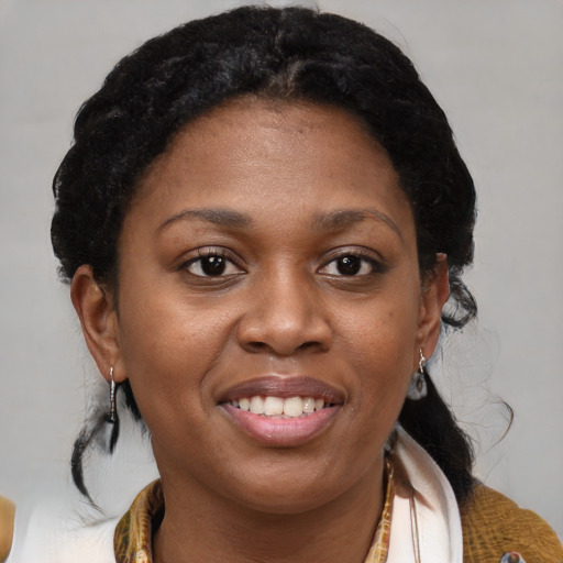 Joyful black young-adult female with medium  brown hair and brown eyes