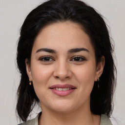 Joyful latino young-adult female with medium  brown hair and brown eyes