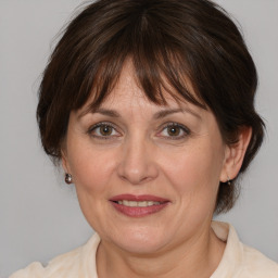 Joyful white adult female with medium  brown hair and brown eyes