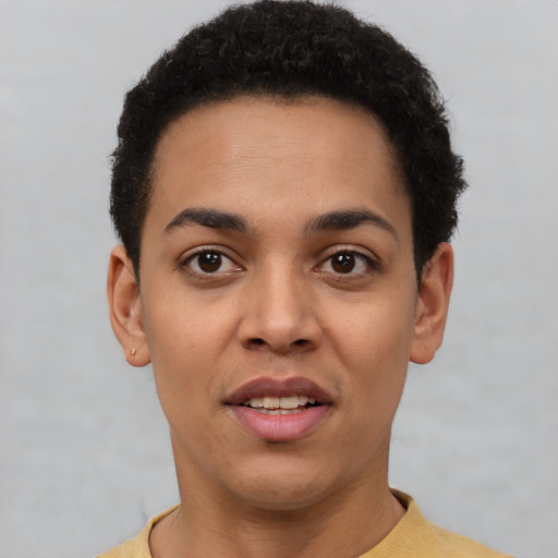 Joyful latino young-adult female with short  black hair and brown eyes