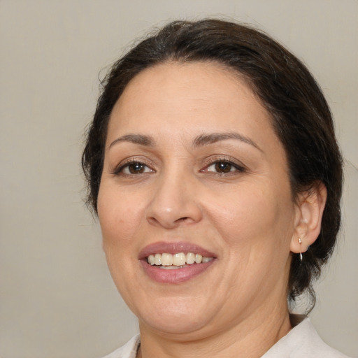 Joyful white adult female with medium  brown hair and brown eyes