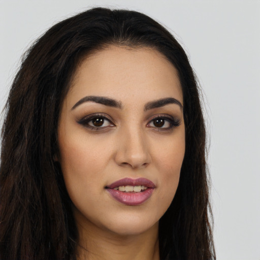 Joyful white young-adult female with long  brown hair and brown eyes