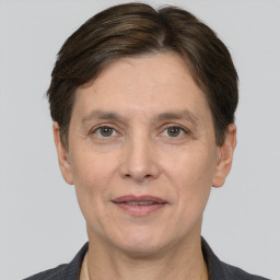 Joyful white adult female with short  brown hair and grey eyes