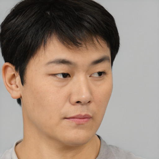 Neutral asian young-adult male with short  brown hair and brown eyes