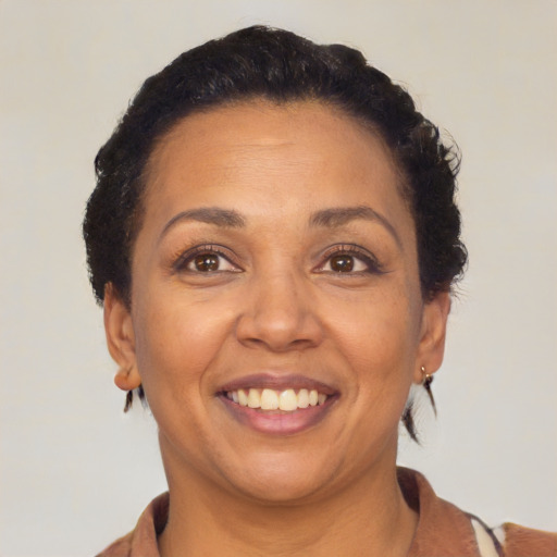 Joyful latino adult female with short  brown hair and brown eyes