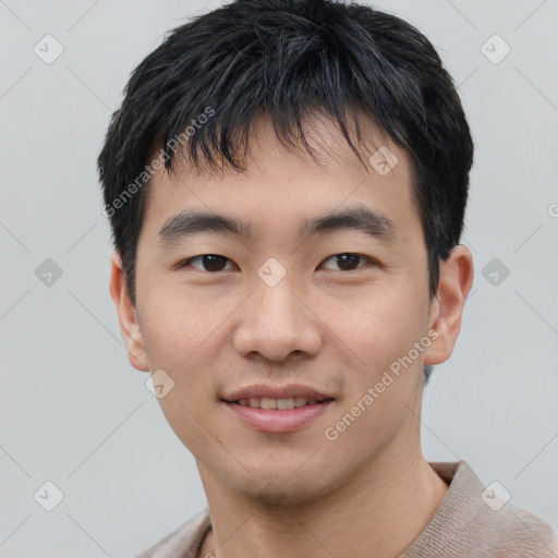 Joyful asian young-adult male with short  black hair and brown eyes