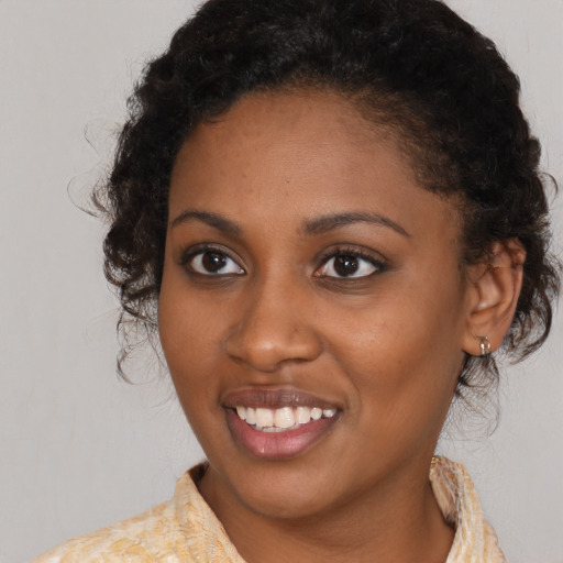 Joyful black young-adult female with medium  brown hair and brown eyes
