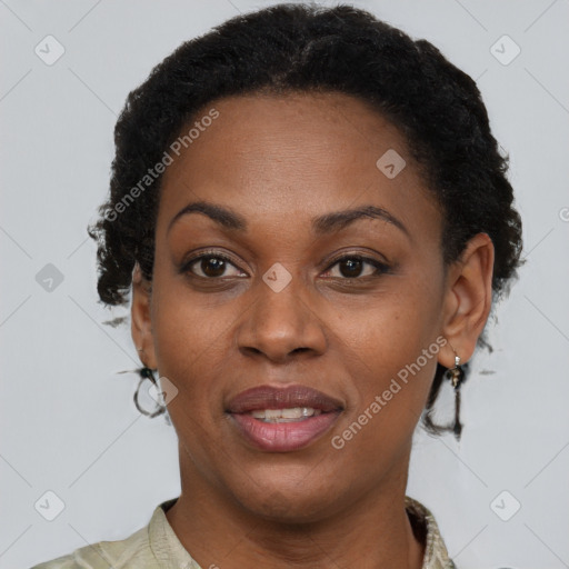 Joyful black adult female with short  brown hair and brown eyes