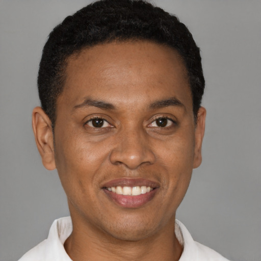 Joyful black young-adult male with short  black hair and brown eyes