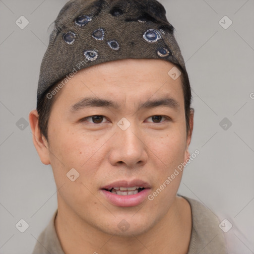 Joyful asian young-adult male with short  brown hair and brown eyes