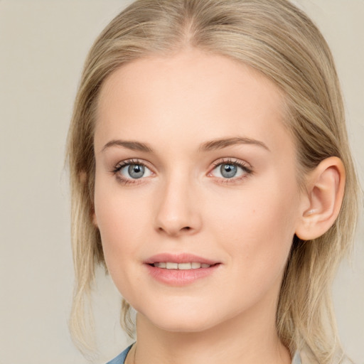 Joyful white young-adult female with medium  brown hair and blue eyes