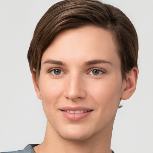 Joyful white young-adult female with short  brown hair and grey eyes